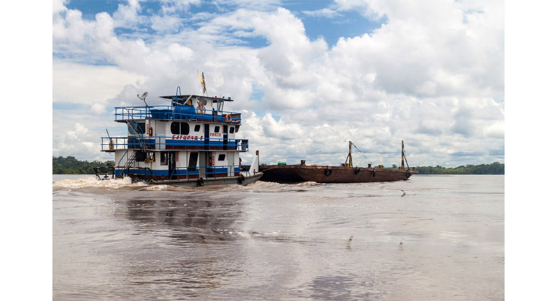 Typical Amazon Boat and barge with Brazil nuts in shell on the way for processing.